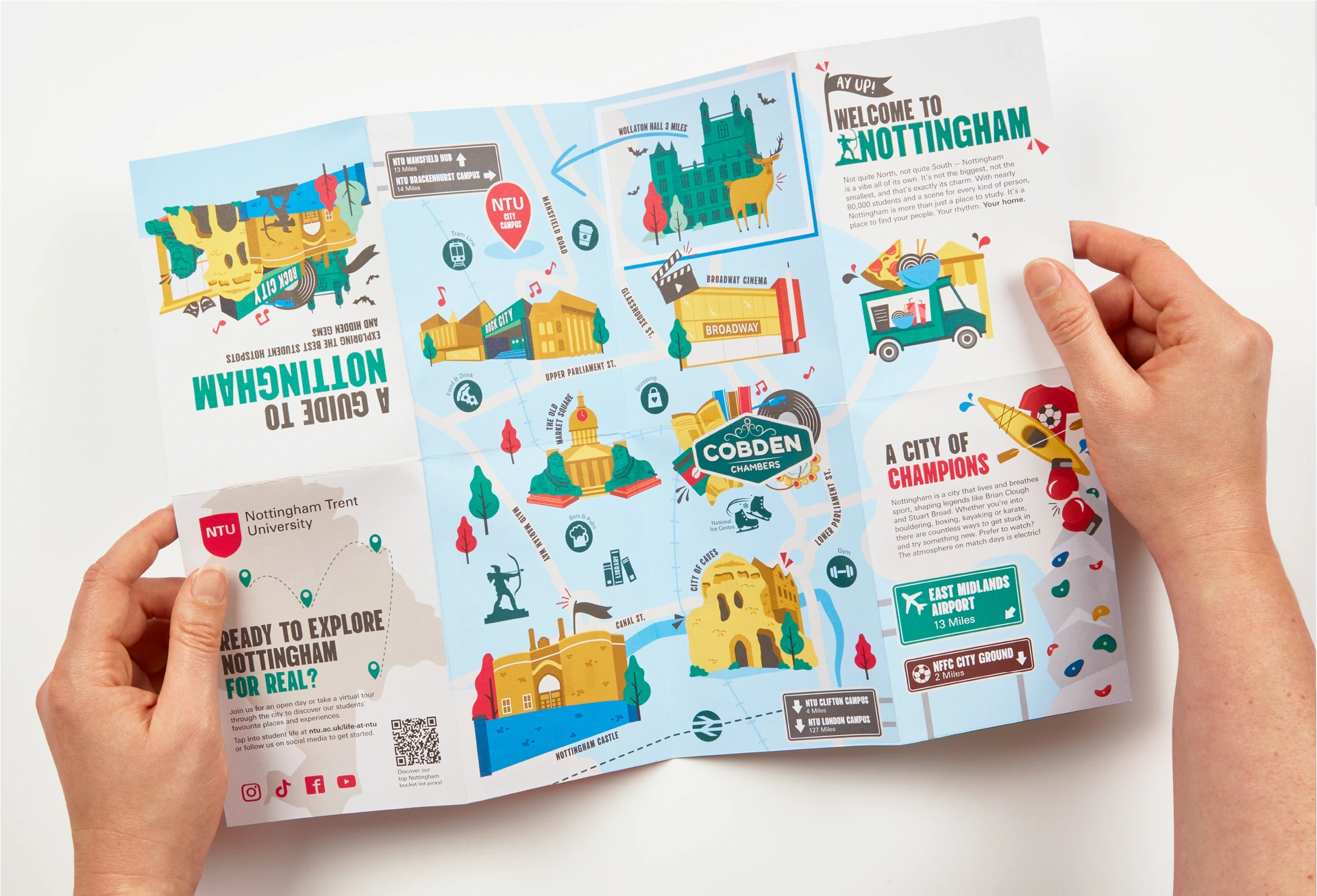Hands holding a printed fold out guide to Nottingham. Designed illustrated and printed for Nottingham Trent University.