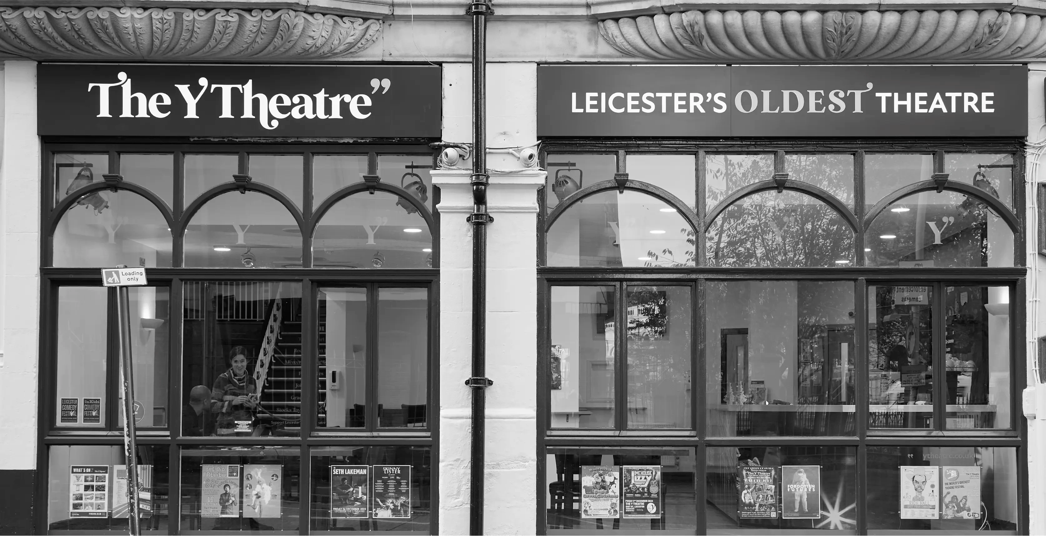 Black and white photograph of the exterior signage of The Y Theatre Leicester's oldest theatre.