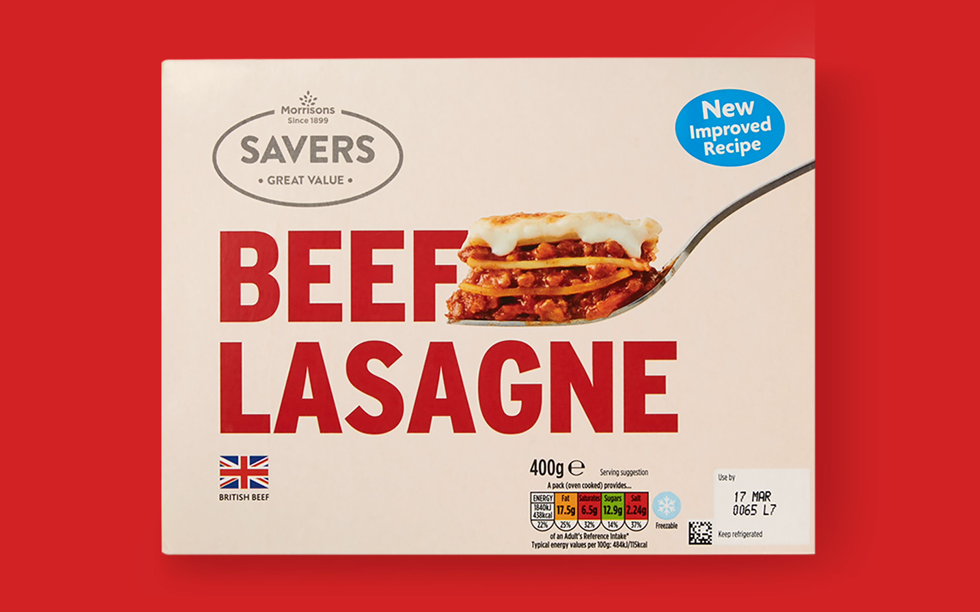 Photography of a Morrisons Savers Beef Lasagne box with bold typography, shot on a red background.