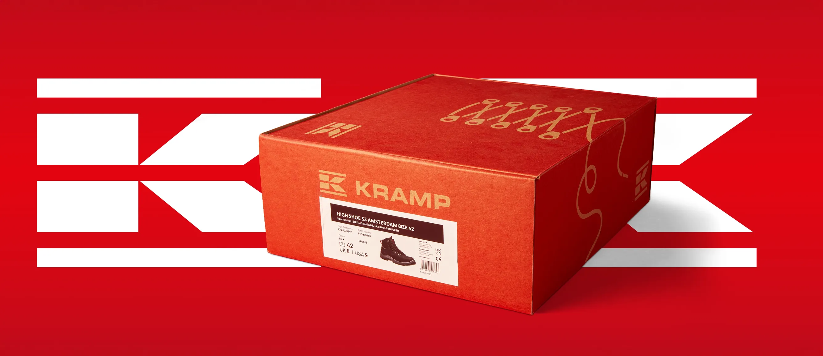 Red Kramp shoe box, shot at a 3/4 angle, against a red background, with two Kramp logos.