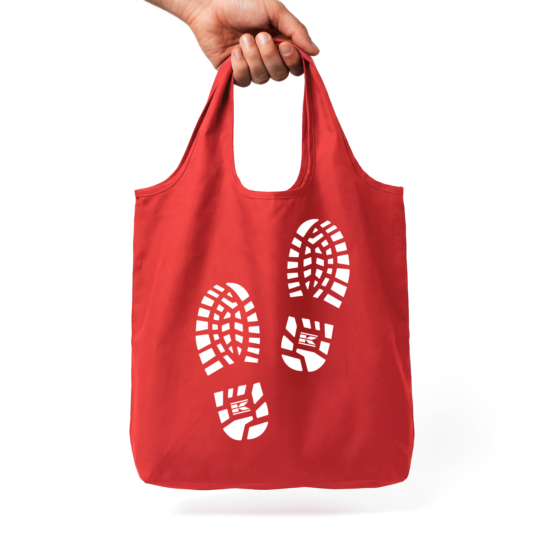 Red Kramp tote bag held in hand in a white studio.